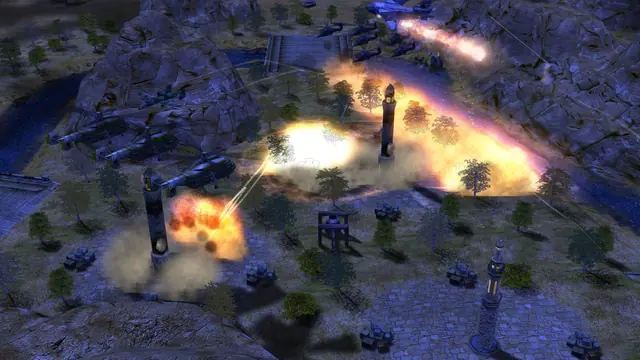 A village at night lit by fires, with helicopters and a jet firing from above
