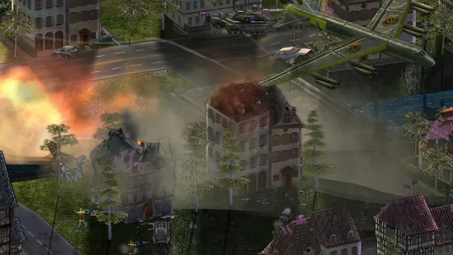 A bomber flying low over a village as houses burn and smoke hangs over the street